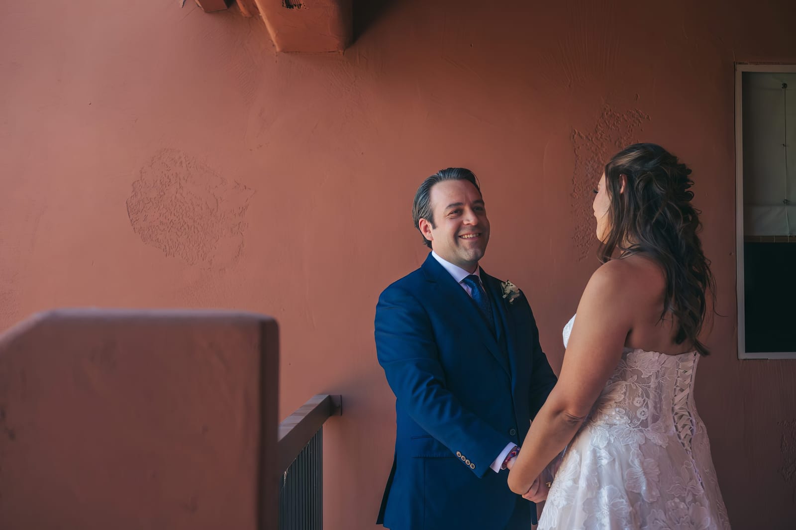 Dina glancing back at Erick and smiling during their first look